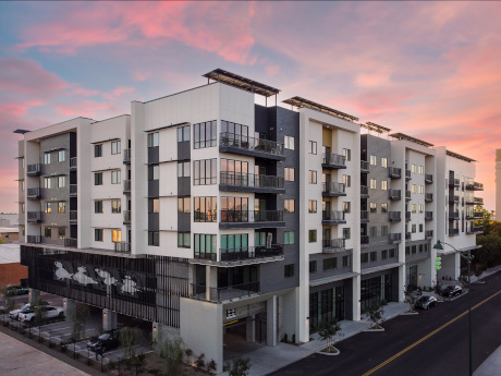A multi-family residential building with multiple floors and balconies.