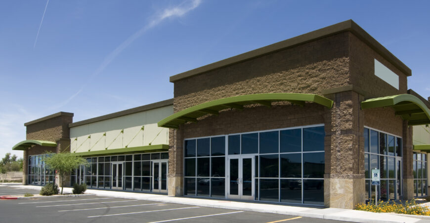 A bustling retail space with storefronts and shoppers.